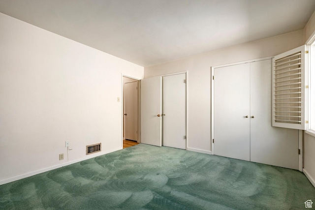 420 E 12th Ave, Salt Lake City, UT 84103 - unfurnished bedroom featuring two closets and carpet