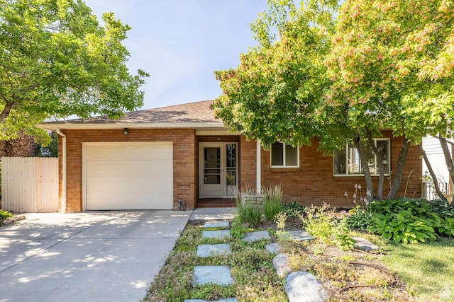420 E 12th Ave, Salt Lake City, UT 84103 - view of front of property with a garage, brick siding, driveway, and a shingled roof