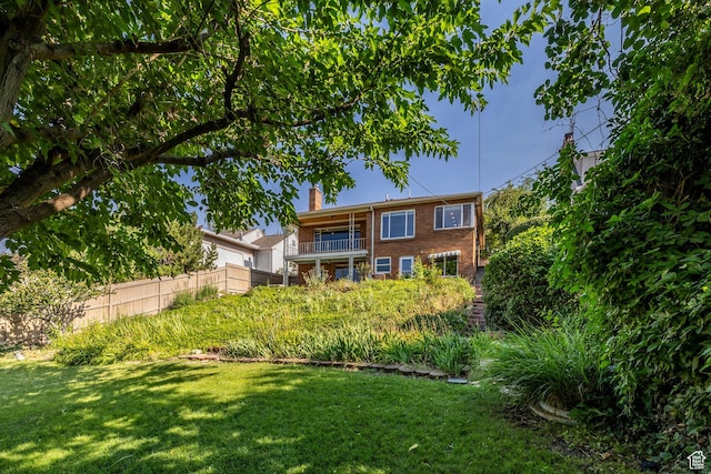 420 E 12th Ave, Salt Lake City, UT 84103 - rear view of house featuring a balcony, a chimney, and brick siding