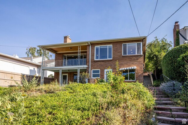 420 E 12th Ave, Salt Lake City, UT 84103 - rear view of house featuring brick siding, stairs, a chimney, and a balcony