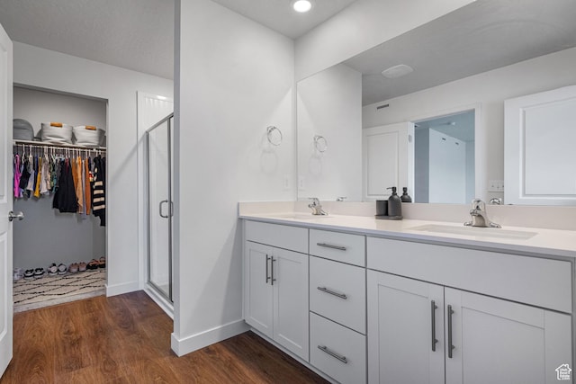 937 W Terracotta Dr, Saratoga Springs, UT 84045 - bathroom with double vanity, wood finished floors, a stall shower, and a spacious closet