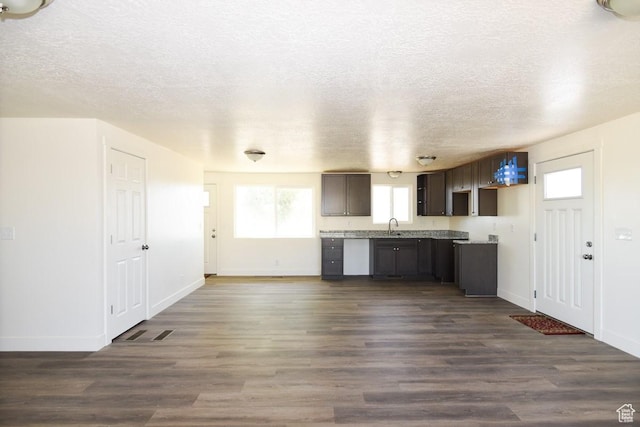 327 N 600 W, Grantsville, UT 84029 - kitchen with light countertops, a textured ceiling, dark wood finished floors, and dark brown cabinets