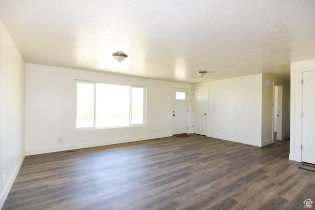 327 N 600 W, Grantsville, UT 84029 - unfurnished living room with baseboards and dark wood-type flooring