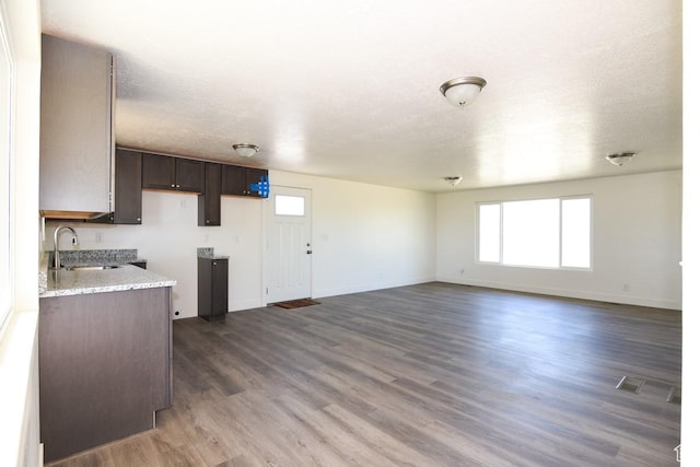 327 N 600 W, Grantsville, UT 84029 - kitchen with dark brown cabinets, wood finished floors, and light stone counters