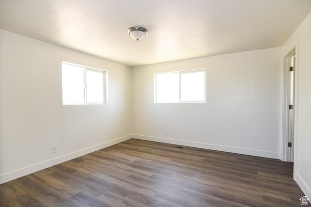 327 N 600 W, Grantsville, UT 84029 - spare room with healthy amount of natural light and dark wood-style flooring