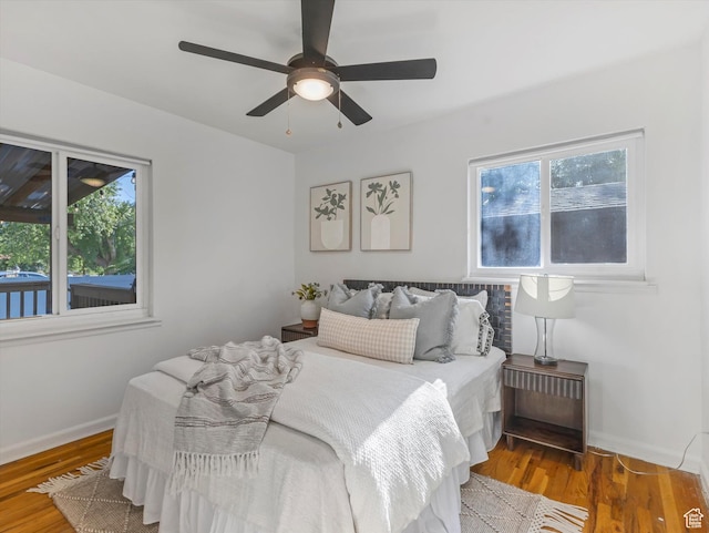 1406 W Talisman Dr, Salt Lake City, UT 84116 - bedroom with multiple windows, wood finished floors, and a ceiling fan