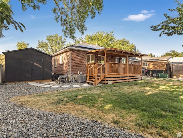 1406 W Talisman Dr, Salt Lake City, UT 84116 - back of property featuring a storage shed, brick siding, a yard, solar panels, and a wooden deck