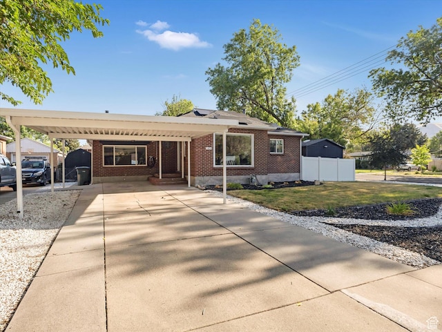 1406 W Talisman Dr, Salt Lake City, UT 84116 - ranch-style home with brick siding, an attached carport, and driveway