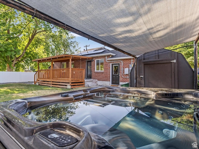 1406 W Talisman Dr, Salt Lake City, UT 84116 - view of front of house featuring a wooden deck, brick siding, and a storage shed