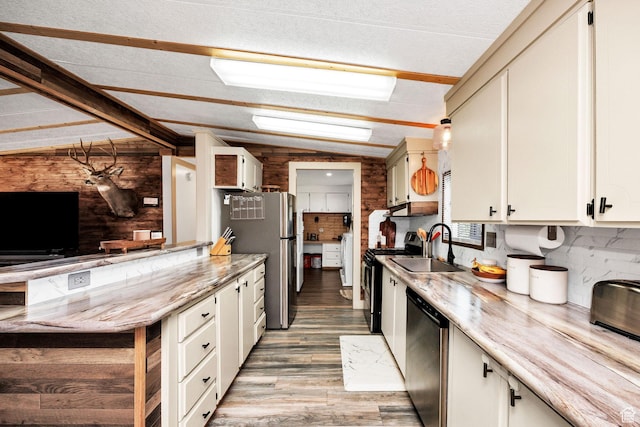 20105 N 5000 W, Plymouth, UT 84330 - kitchen with stainless steel appliances, lofted ceiling, wooden walls, light wood-type flooring, and white cabinetry