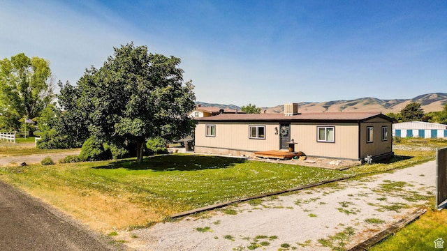 20105 N 5000 W, Plymouth, UT 84330 - view of front of house with a mountain view and a front lawn