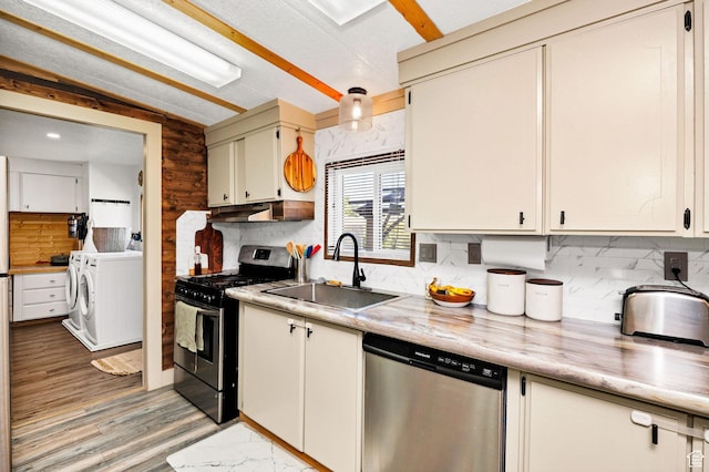 20105 N 5000 W, Plymouth, UT 84330 - kitchen featuring appliances with stainless steel finishes, washing machine and clothes dryer, light countertops, and decorative backsplash
