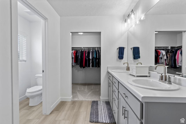 1162 W 1100 S, Clearfield, UT 84015 - bathroom with double vanity, a walk in closet, and a textured ceiling