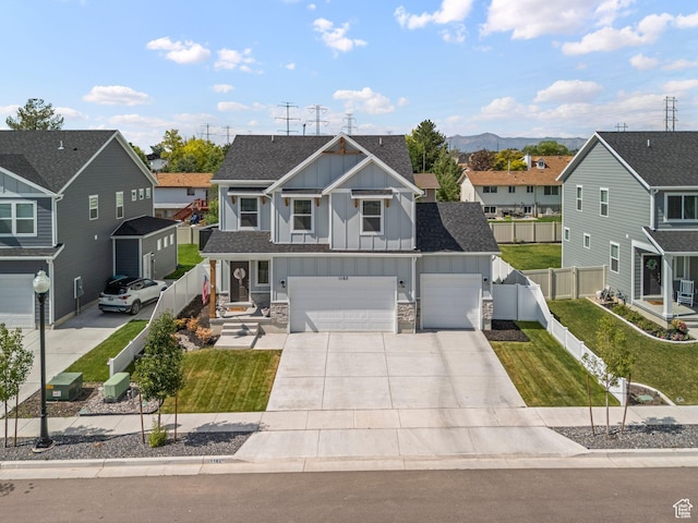 1162 W 1100 S, Clearfield, UT 84015 - view of front facade featuring board and batten siding, a residential view, driveway, a garage, and stone siding