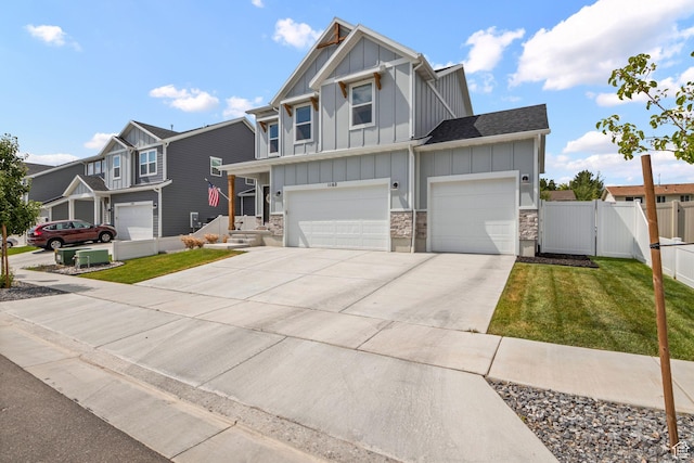 1162 W 1100 S, Clearfield, UT 84015 - craftsman inspired home with board and batten siding, concrete driveway, a garage, stone siding, and a residential view