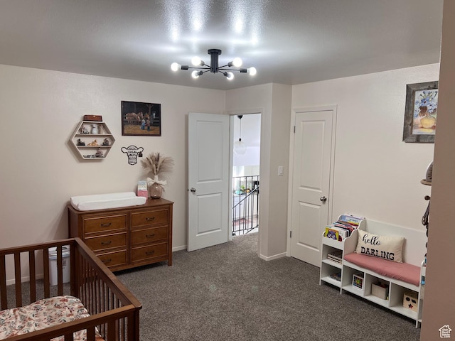 695 N Orange Ct, Castle Dale, UT 84513 - bedroom with a chandelier, a crib, and dark colored carpet