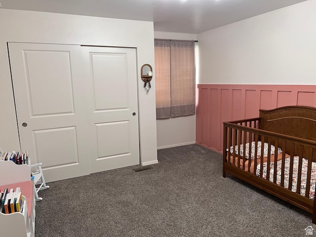 695 N Orange Ct, Castle Dale, UT 84513 - bedroom with carpet, a nursery area, wainscoting, and a closet