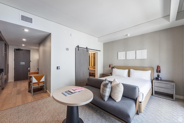 2417 W High Mountain Rd Unit 2416, Park City, UT 84098 - bedroom featuring a barn door, light wood-type flooring, recessed lighting, and ensuite bathroom