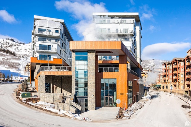 2417 W High Mountain Rd Unit 2416, Park City, UT 84098 - snow covered building featuring a mountain view and a view of apartment building / complex