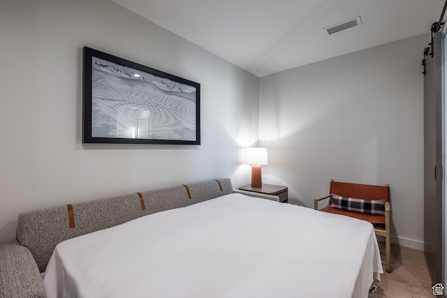 2417 W High Mountain Rd Unit 2416, Park City, UT 84098 - bedroom featuring a barn door and wood finished floors