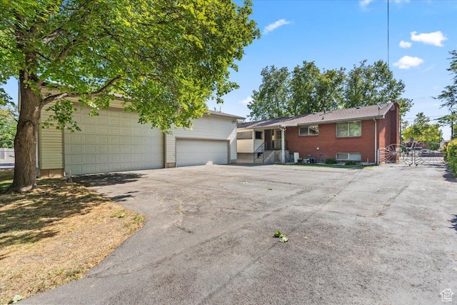 7738 S 2700 W, West Jordan, UT 84084 - view of front of property with a garage, an outdoor structure, and brick siding