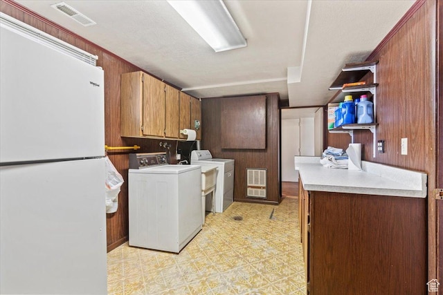 7738 S 2700 W, West Jordan, UT 84084 - washroom with cabinet space, washer and clothes dryer, wood walls, and light floors