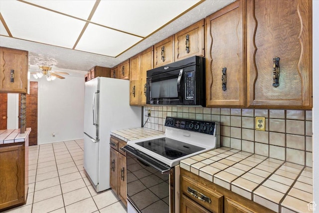 7738 S 2700 W, West Jordan, UT 84084 - kitchen with white appliances, tile counters, brown cabinetry, and tasteful backsplash