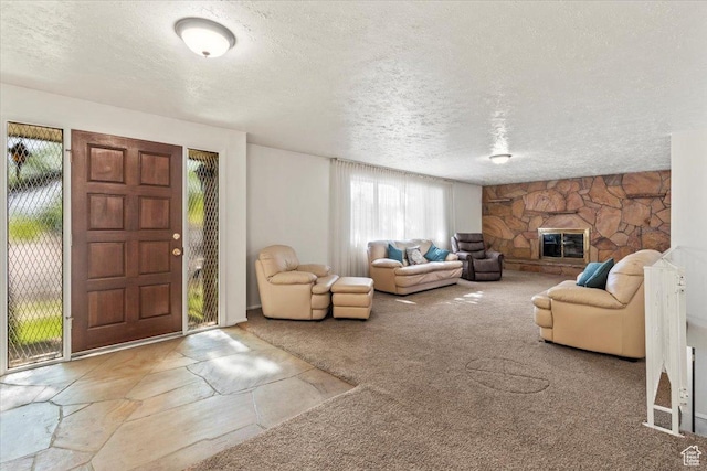 7738 S 2700 W, West Jordan, UT 84084 - living area with healthy amount of natural light, a textured ceiling, carpet floors, and a stone fireplace