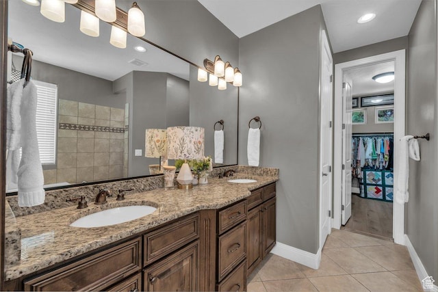 38 W 1725 S, Washington, UT 84780 - full bath featuring double vanity, a walk in closet, tile patterned flooring, and tiled shower