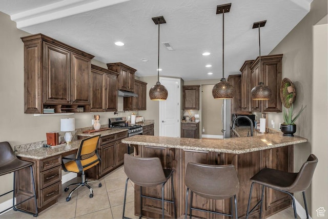 38 W 1725 S, Washington, UT 84780 - kitchen featuring stainless steel gas range oven, built in study area, recessed lighting, dark brown cabinetry, and a peninsula