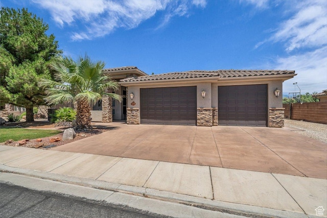 38 W 1725 S, Washington, UT 84780 - view of front facade featuring stone siding, stucco siding, an attached garage, a tiled roof, and concrete driveway