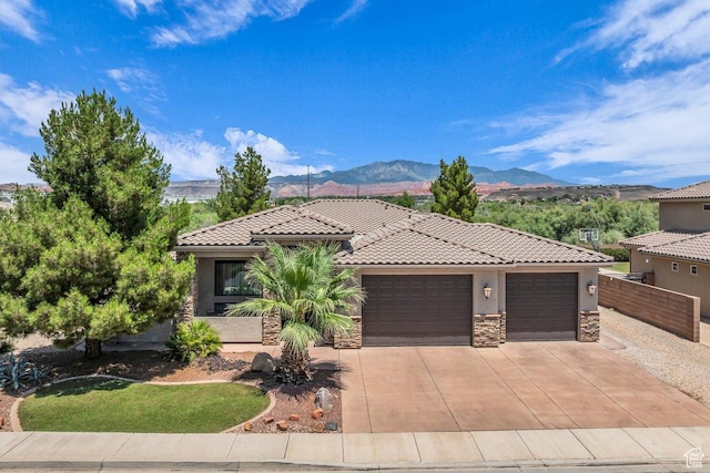 38 W 1725 S, Washington, UT 84780 - mediterranean / spanish-style house with stone siding, stucco siding, a garage, driveway, and a tile roof