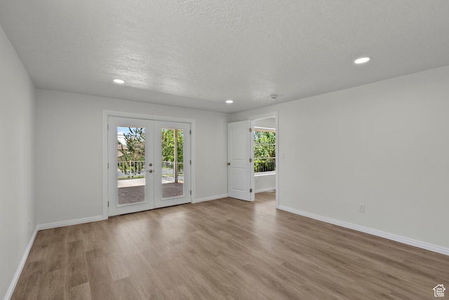 1175 E 900 N, Lehi, UT 84043 - unfurnished room with french doors, light wood-style floors, recessed lighting, and a textured ceiling