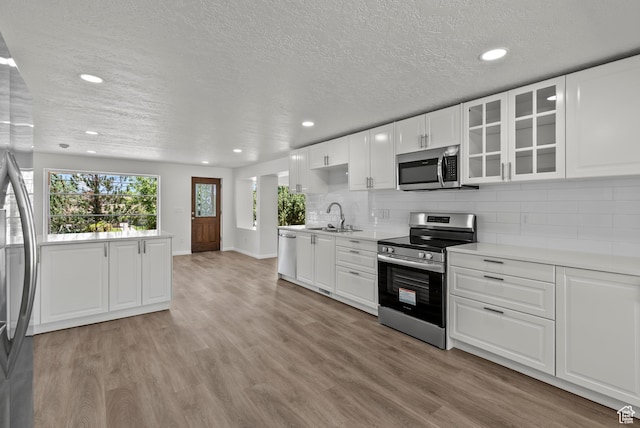 1175 E 900 N, Lehi, UT 84043 - kitchen featuring appliances with stainless steel finishes, recessed lighting, light wood-style floors, a textured ceiling, and light countertops
