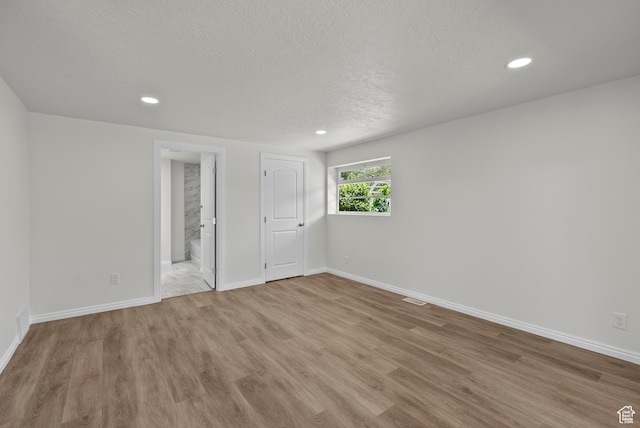 1175 E 900 N, Lehi, UT 84043 - unfurnished bedroom featuring wood finished floors, recessed lighting, a textured ceiling, and ensuite bathroom