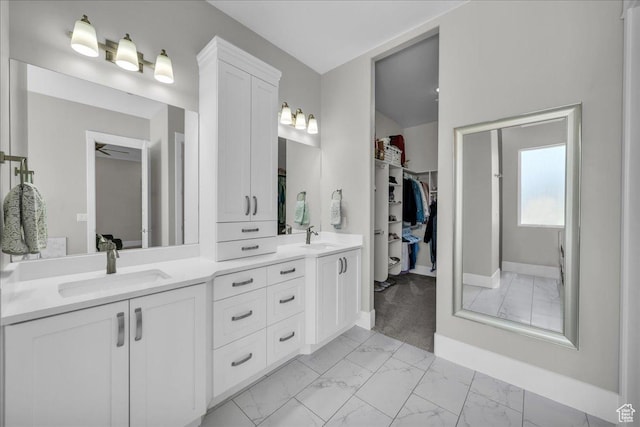 2249 E Fieldstone Cir, St George, UT 84790 - bathroom featuring marble finish floors, double vanity, and a spacious closet