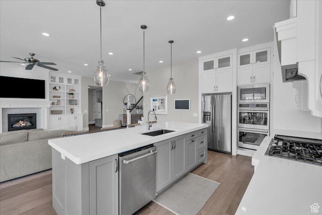 2249 E Fieldstone Cir, St George, UT 84790 - kitchen with appliances with stainless steel finishes, a ceiling fan, light countertops, an island with sink, and recessed lighting