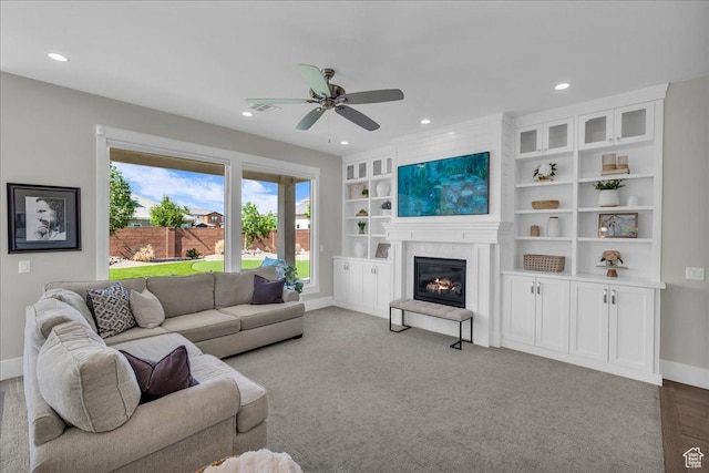 2249 E Fieldstone Cir, St George, UT 84790 - living room with ceiling fan, recessed lighting, a glass covered fireplace, and built in features