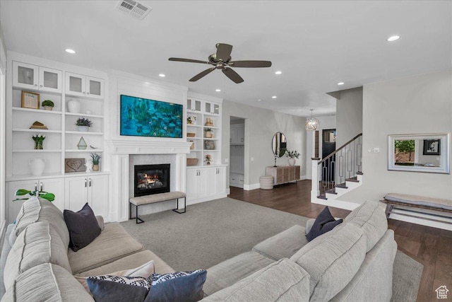 2249 E Fieldstone Cir, St George, UT 84790 - living room with stairway, recessed lighting, a ceiling fan, a glass covered fireplace, and built in shelves