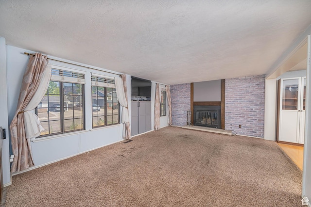 564 S 940 W, Cedar City, UT 84720 - unfurnished living room featuring a textured ceiling, a large fireplace, and carpet flooring