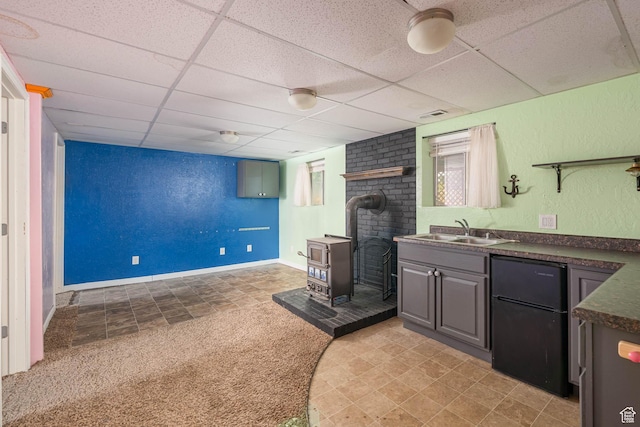 564 S 940 W, Cedar City, UT 84720 - bar featuring a wood stove, freestanding refrigerator, a paneled ceiling, and light carpet