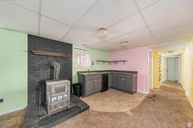564 S 940 W, Cedar City, UT 84720 - kitchen with gray cabinets, freestanding refrigerator, a paneled ceiling, a wood stove, and light carpet
