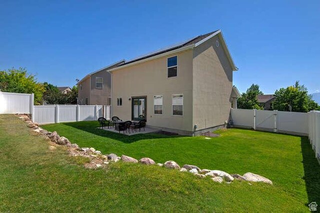 7526 S Park Maple Dr, West Jordan, UT 84081 - back of house featuring a fenced backyard, a patio area, and stucco siding