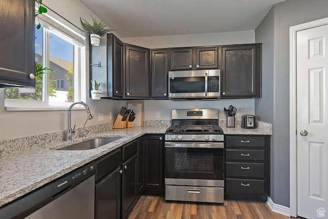 7526 S Park Maple Dr, West Jordan, UT 84081 - kitchen featuring stainless steel appliances, dark wood-style flooring, and light stone counters