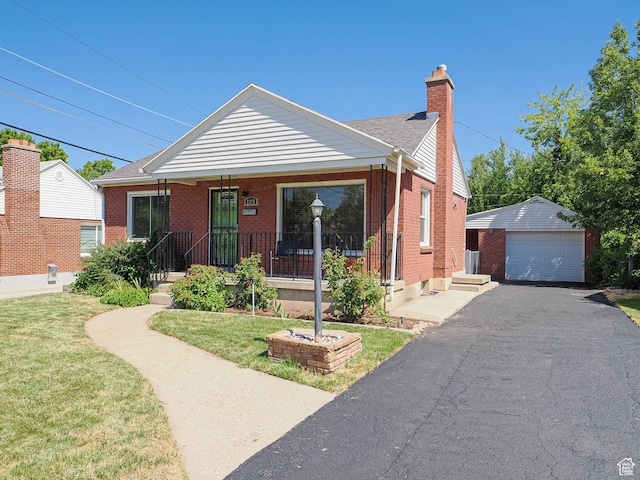 2375 E Redondo Ave, Salt Lake City, UT 84108 - view of front facade with an outbuilding, brick siding, a chimney, a garage, and a front lawn