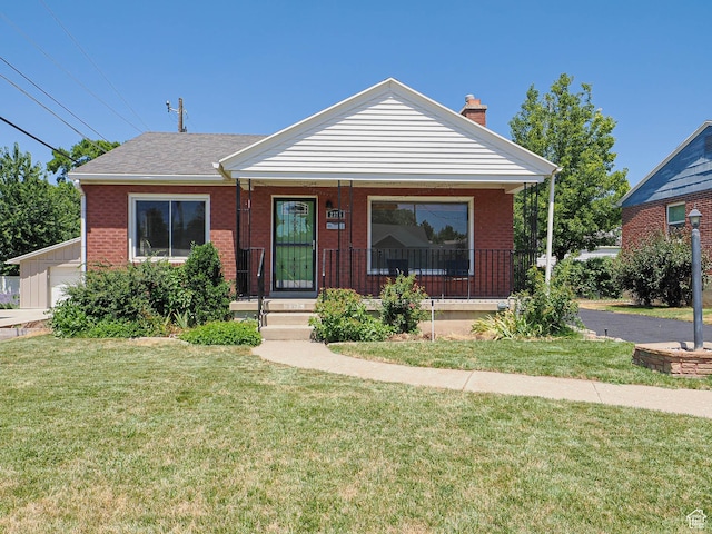 2375 E Redondo Ave, Salt Lake City, UT 84108 - bungalow-style home with covered porch, a front yard, a chimney, and brick siding