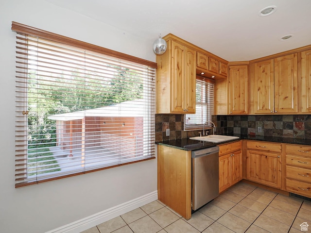 2375 E Redondo Ave, Salt Lake City, UT 84108 - kitchen featuring stainless steel dishwasher, light tile patterned floors, backsplash, and dark countertops