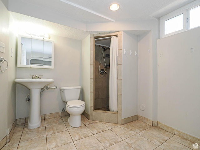 2375 E Redondo Ave, Salt Lake City, UT 84108 - bathroom with tiled shower, tile patterned flooring, and a textured ceiling