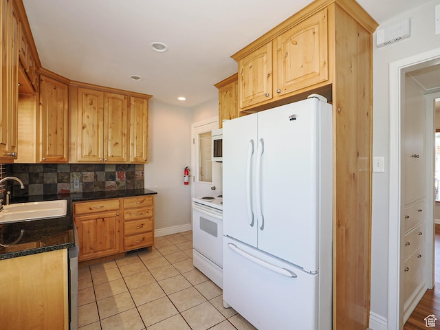 2375 E Redondo Ave, Salt Lake City, UT 84108 - kitchen with white appliances, decorative backsplash, dark countertops, light tile patterned floors, and light brown cabinetry