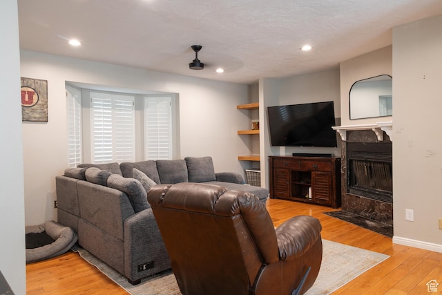11089 S Justin Dr, Sandy, UT 84092 - living room with light wood-type flooring, a tile fireplace, and recessed lighting